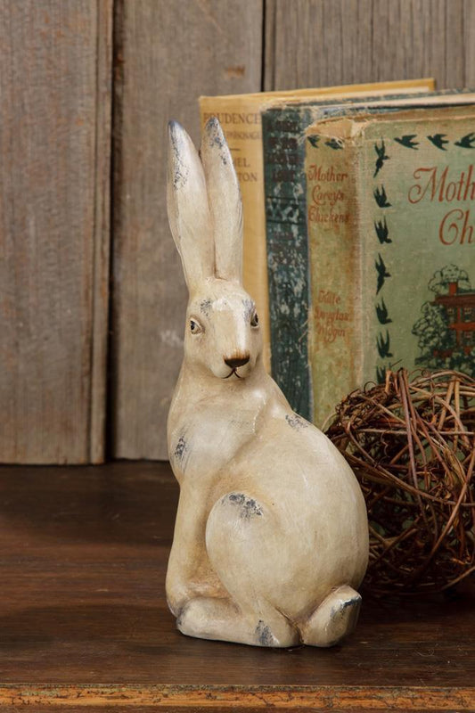 Cute sitting rabbit made of terra cotta with a warm beige distressed finish.  The rabbit is checking out what is behind him and stands 8 inches high.