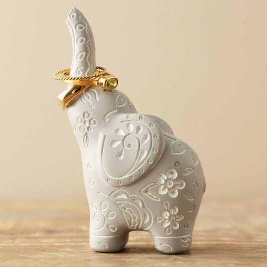 Cute small grey elephant ring holder with intricate white designs throughout.  Stands approximately 3.5 inches high.