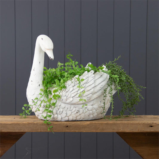 Large swan planter in distressed white finish.  It measures 15 inches high by 17 inches wide by 11 inches deep.  