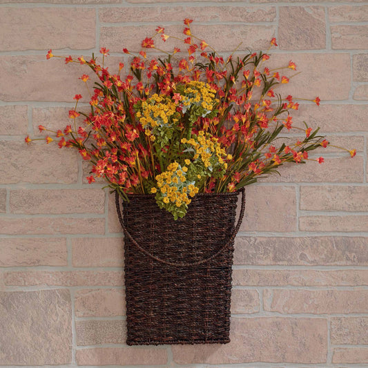 Add seasonal decor pieces, trailing ivy, or a bouquet of faux flowers to our woven seagrass wall pocket. This stylish wall pocket has a beautiful design and coloring that will fit right in with your rustic, country or farmhouse style. A simple way to add instant charm to any room in your home. Woven seagrass over metal frame, measuring 10" wide x 12" high x 2.75" deep.